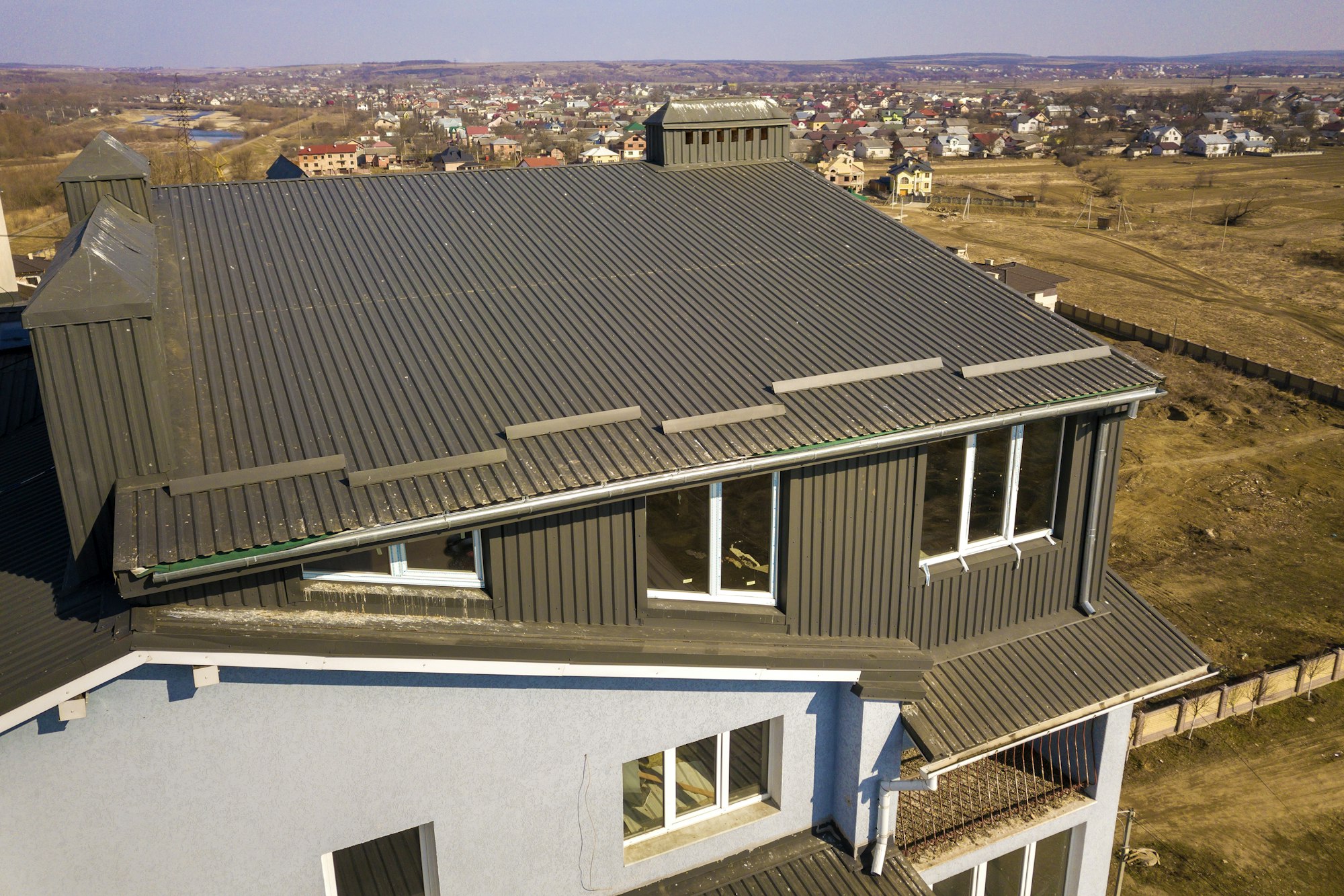 Aerial view of attic annex room exterior with plastic windows, roof and walls