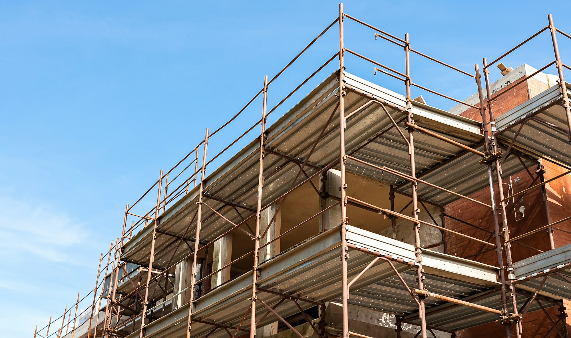 House for renovation with the scaffolding for bricklayers