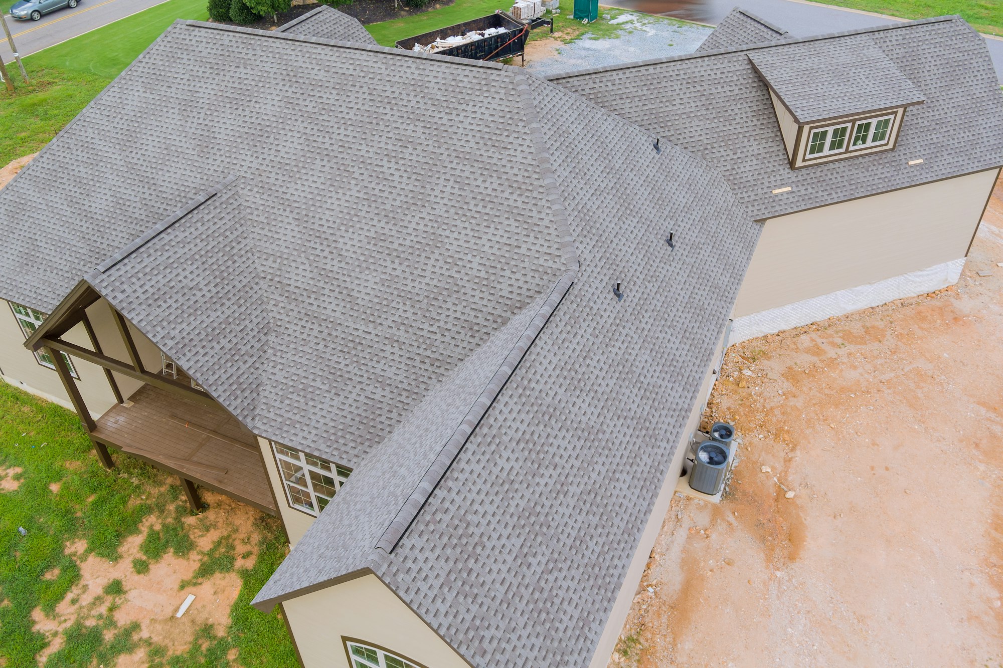 Rubber asphalt roof shingles are being used to cover construction roof of a new house